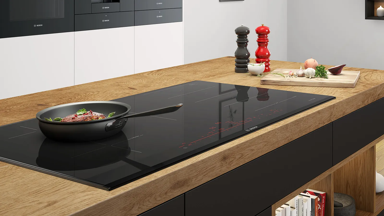 מטבח מודרני עם משטח עץ, כיריים אינדוקציה שחורות וכלי בישול שונים.