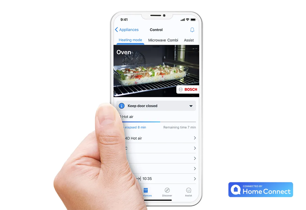 Using the Home Connect app on a smartphone to remotely monitor a dish baking inside a Bosch smart oven.
