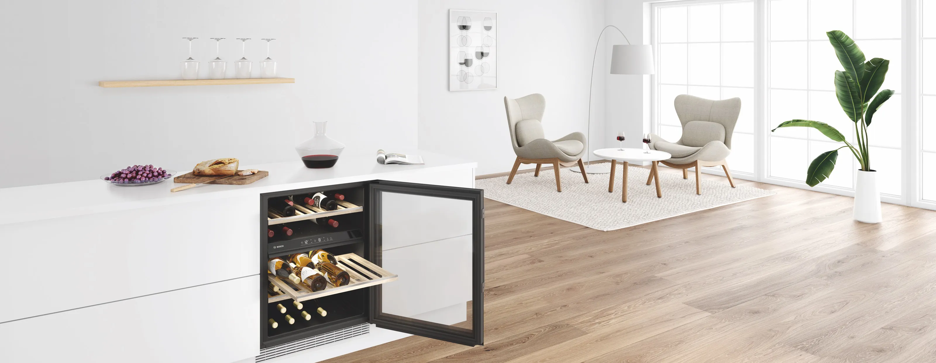 Red wine decanting on the counter above a built-under wine fridge in a modern living room