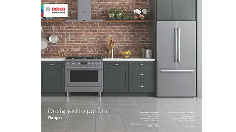 Bosch kitchen with stainless steel range and fridge against a brick wall backdrop.