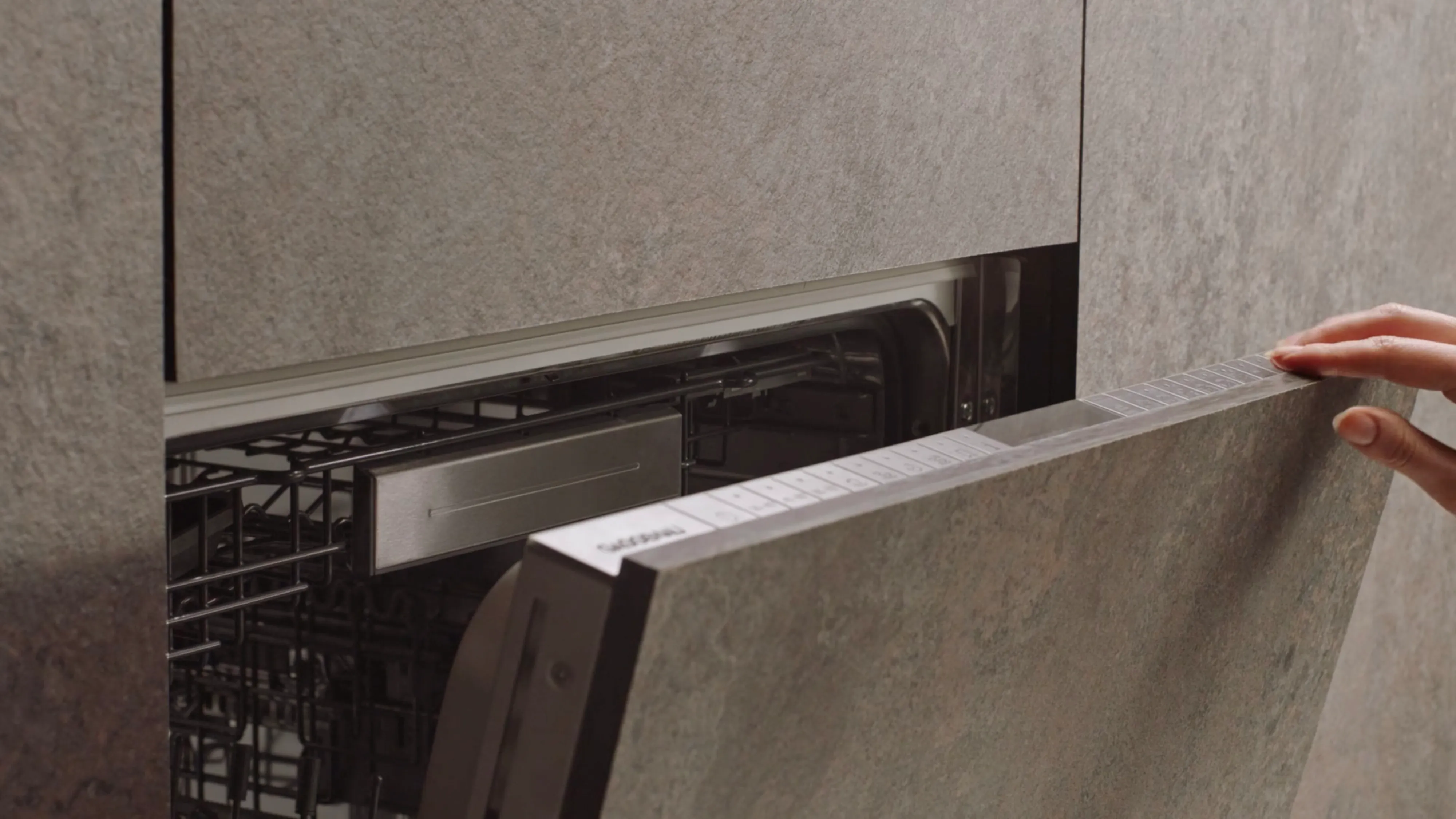 Close-up of the push-to-open functionality of the Gaggenau 400 series dishwasher in a modern kitchen