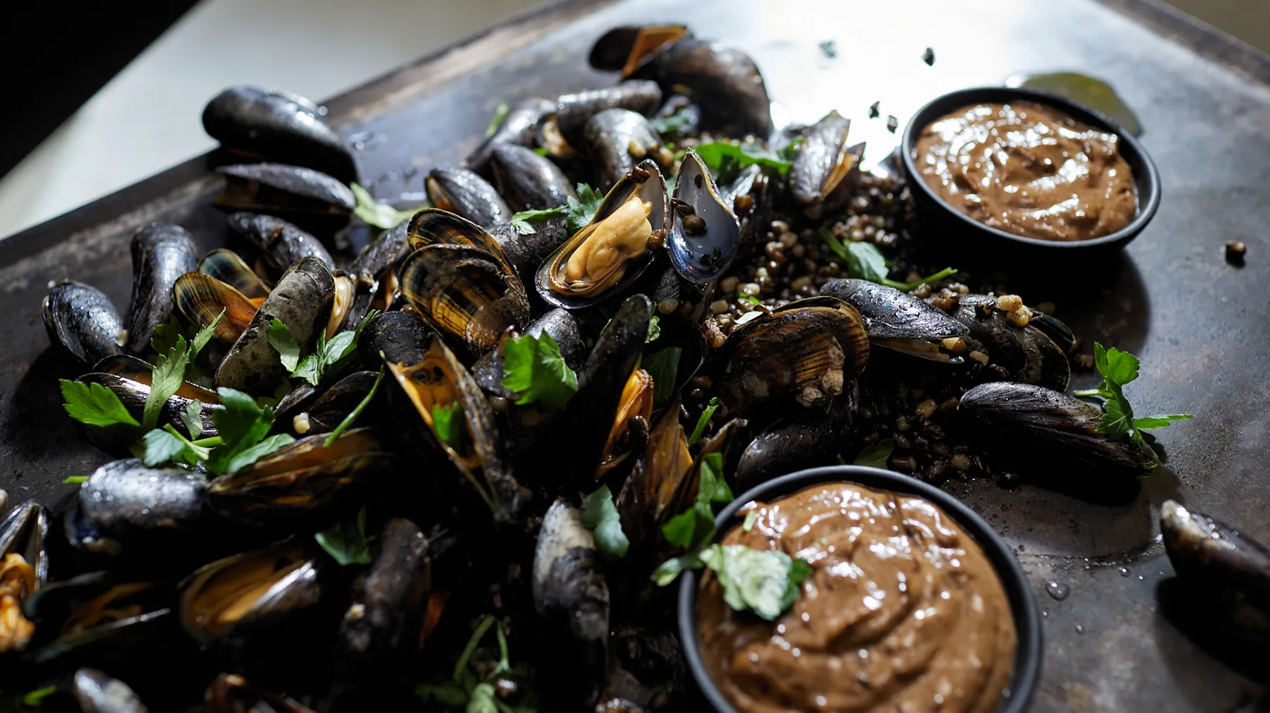 Mussels presented on a dark tray