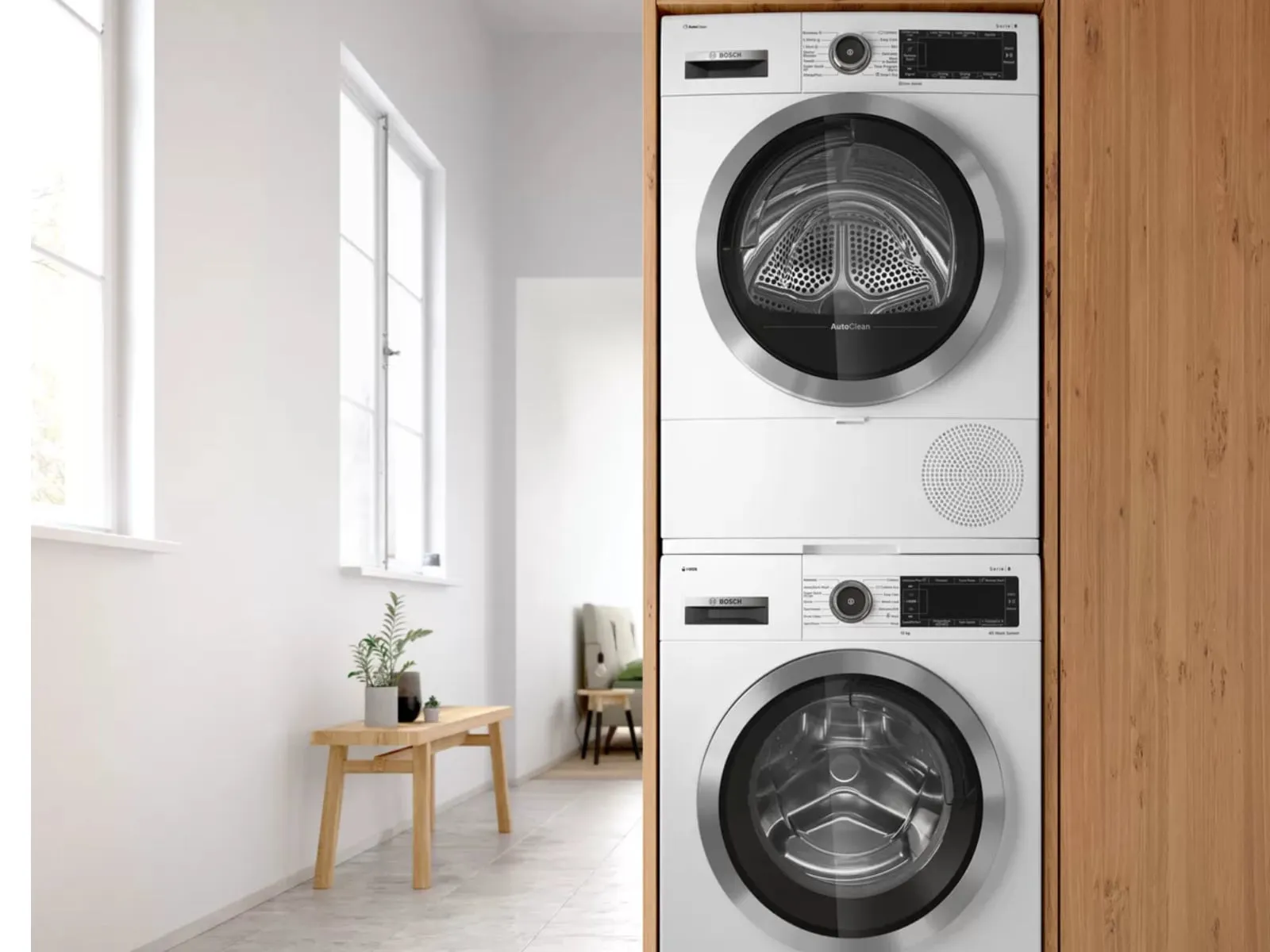 Mașină de spălat și uscător într-o spălătorie modernă, minimalistă cu accente din lemn.