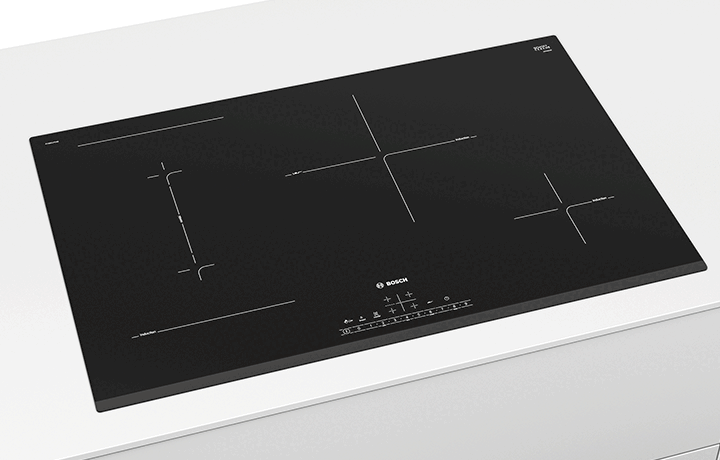 Black induction cooktop with multiple cooking zones and control panel.
