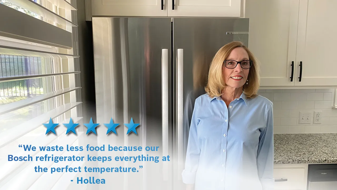 Woman in kitchen with Bosch refrigerator, giving positive review about temperature control.