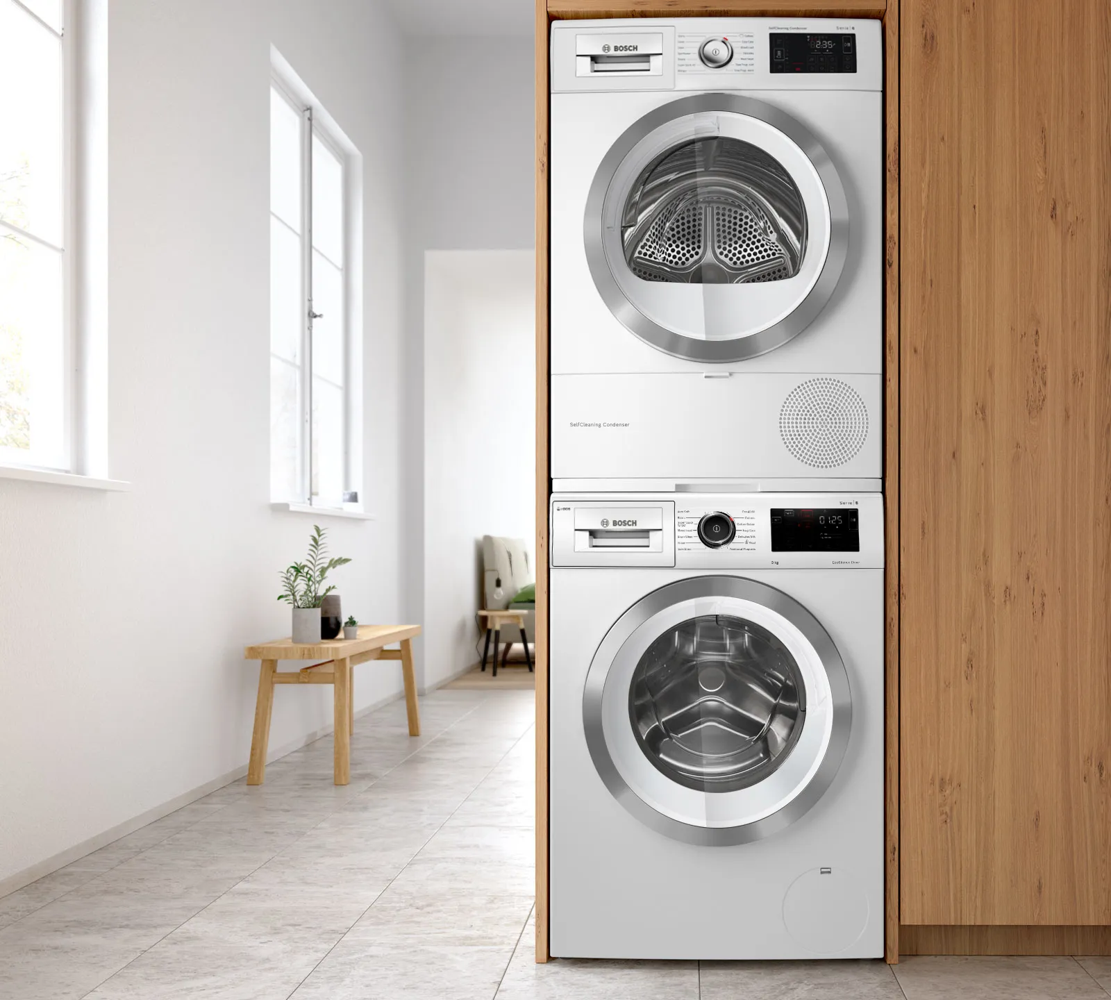Stacked washer and dryer in a modern, minimalist laundry room with wooden accents.