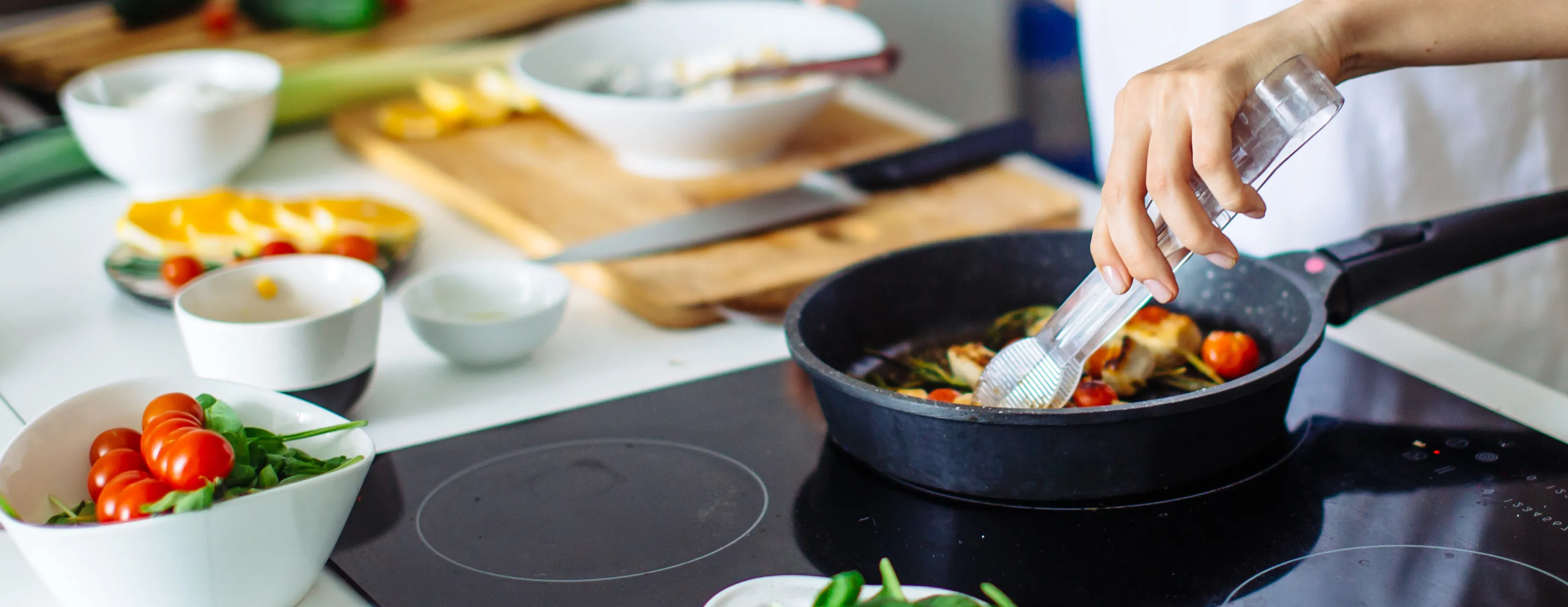 Person cooking on a pan on the hob