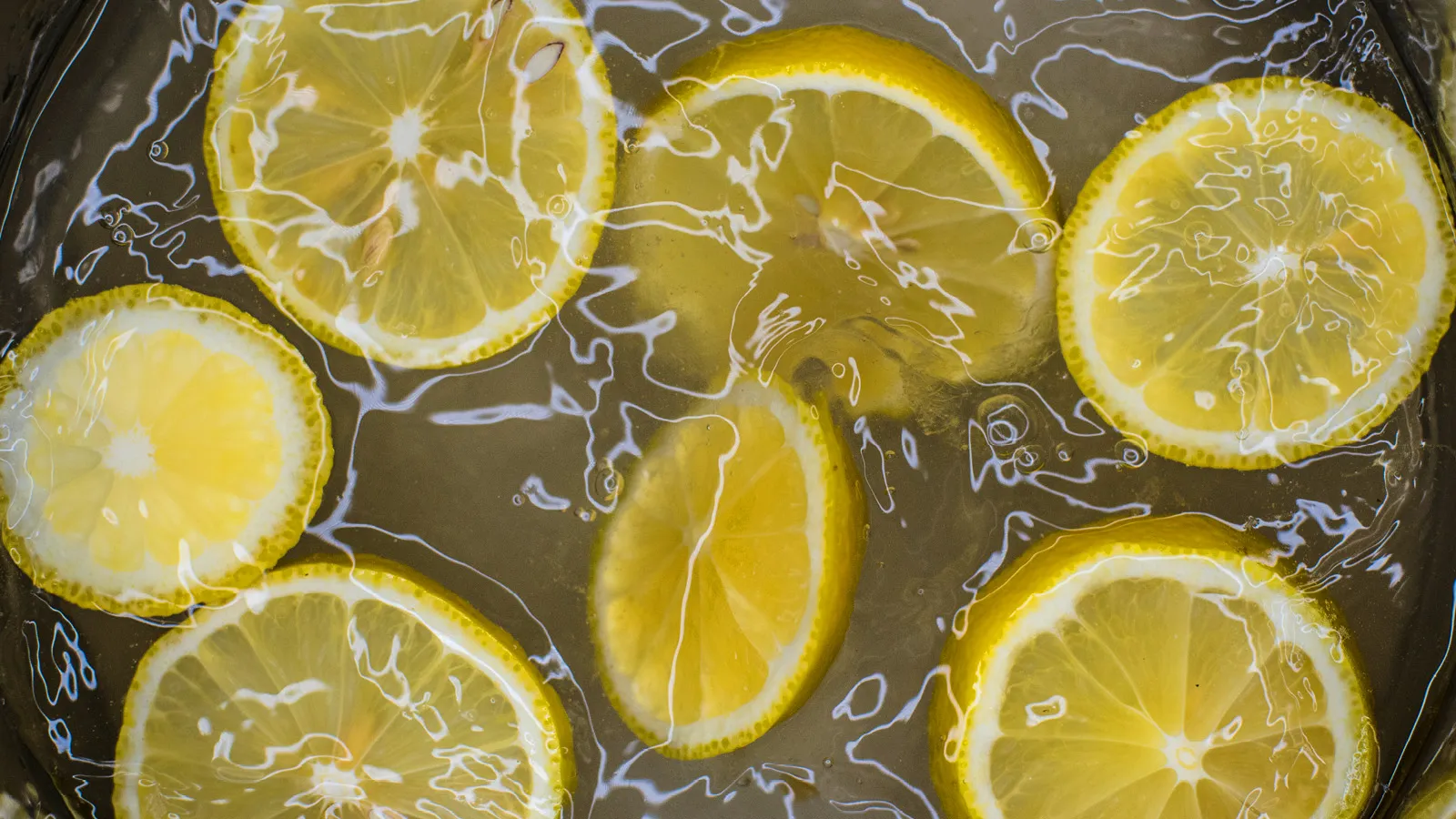 Lemons cut in half sitting in water