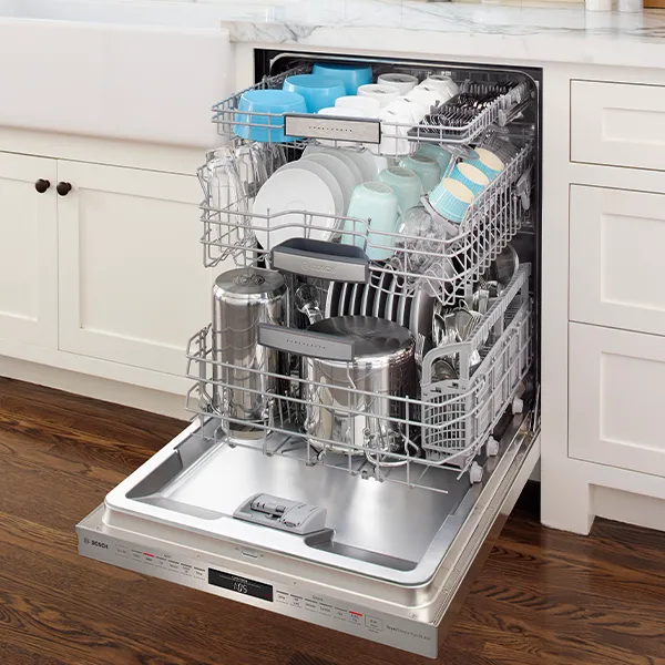 Opened Bosch Dishwasher filled with cleaned dishes and cups