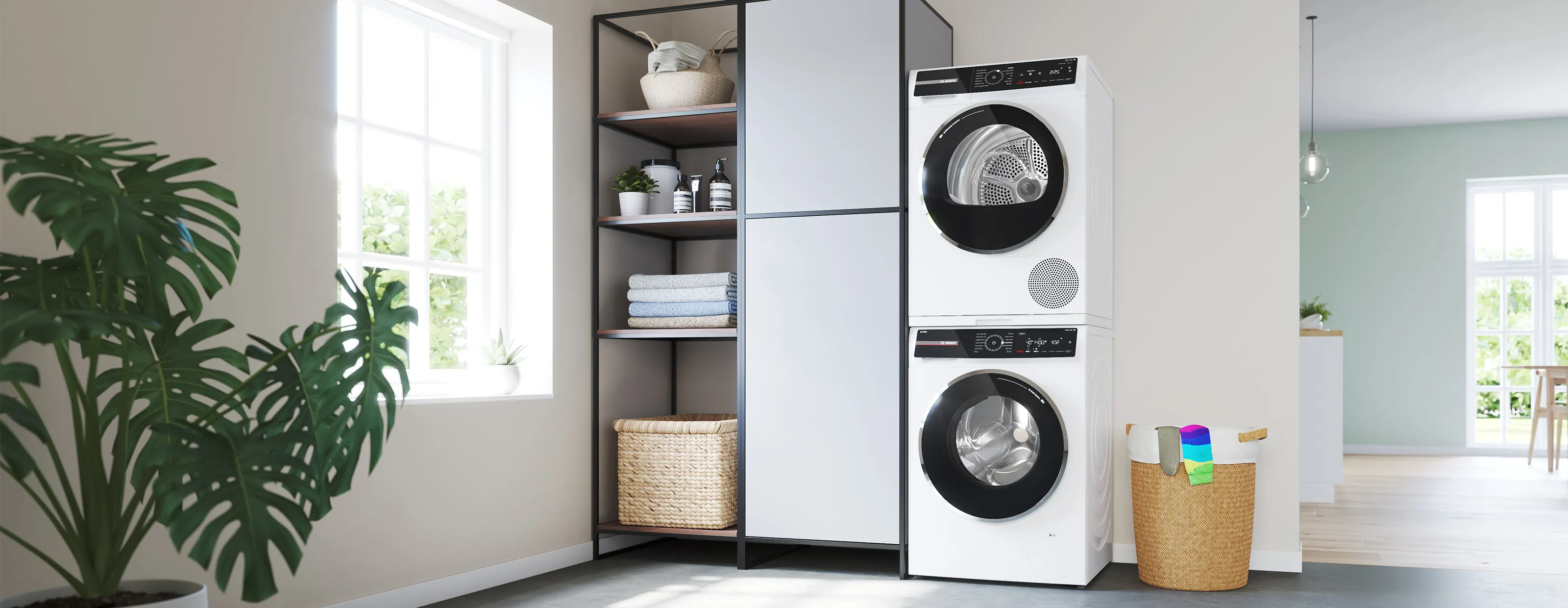 Bosch freestanding washer next to condense dryer in a modern laundry room.