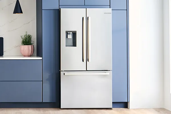 Modern kitchen with Bosch Stainless steel refrigerator, blue cabinets, and potted plant.