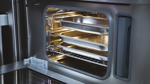 Bosch Oven interior with metal racks and trays, ready for baking or cooking.