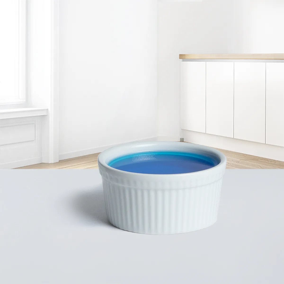 Rinse aid in a bowl on the kitchen cabinet.