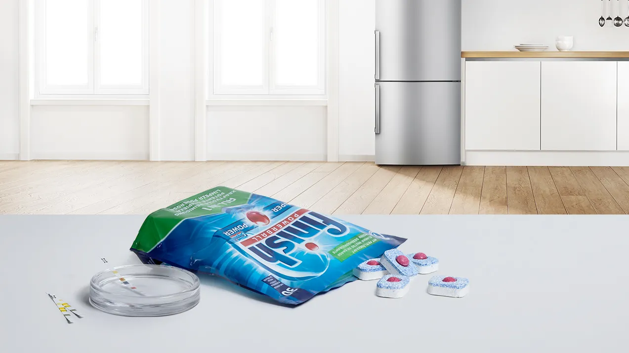 Household appliances, kitchen, detergent package, cleaning supplies, hardwood floor.
