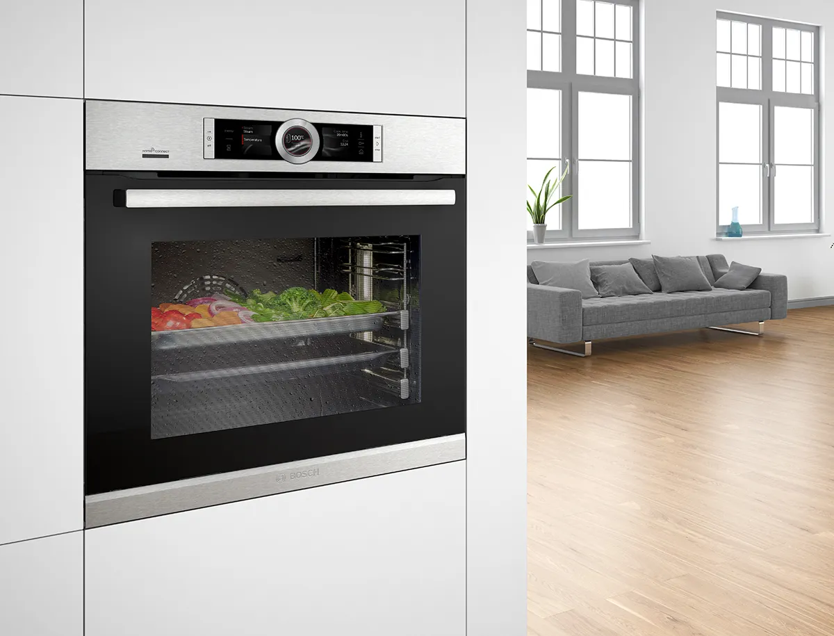 A Bosch steam oven with vegetables inside.