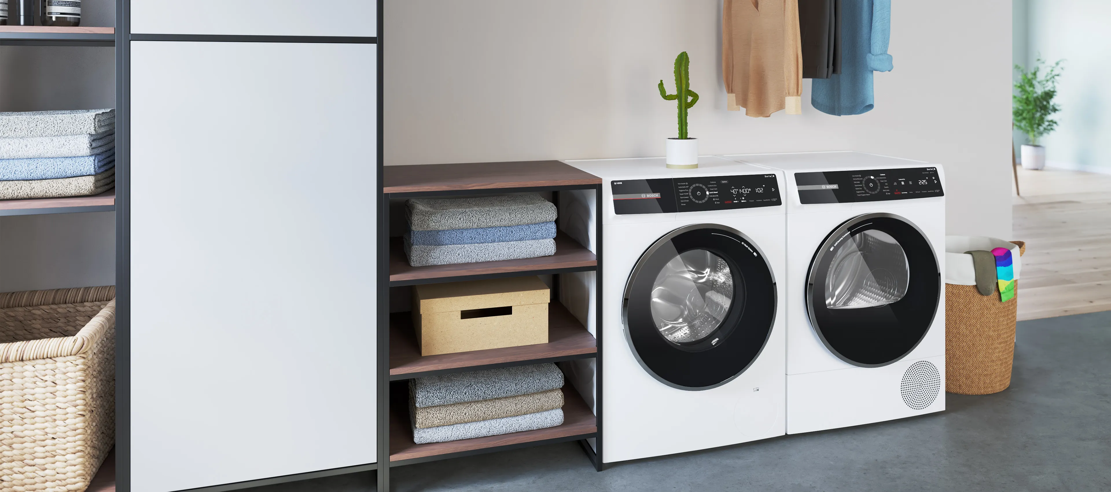 A washer dryer standing in a bright laundry room alongside an open wardrobe containing freshly washed shirts.