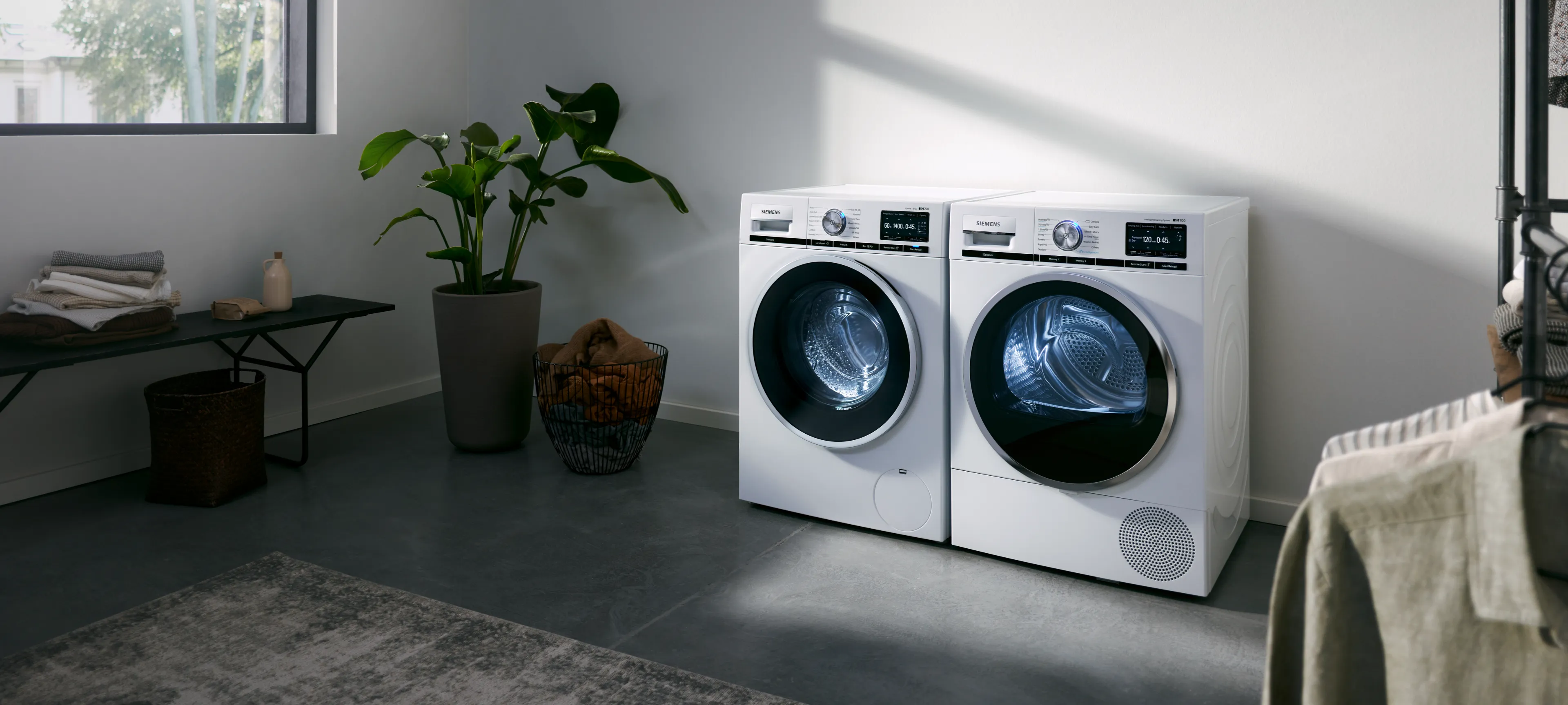 Washing machine and tumble dryer side by side in bright utility room