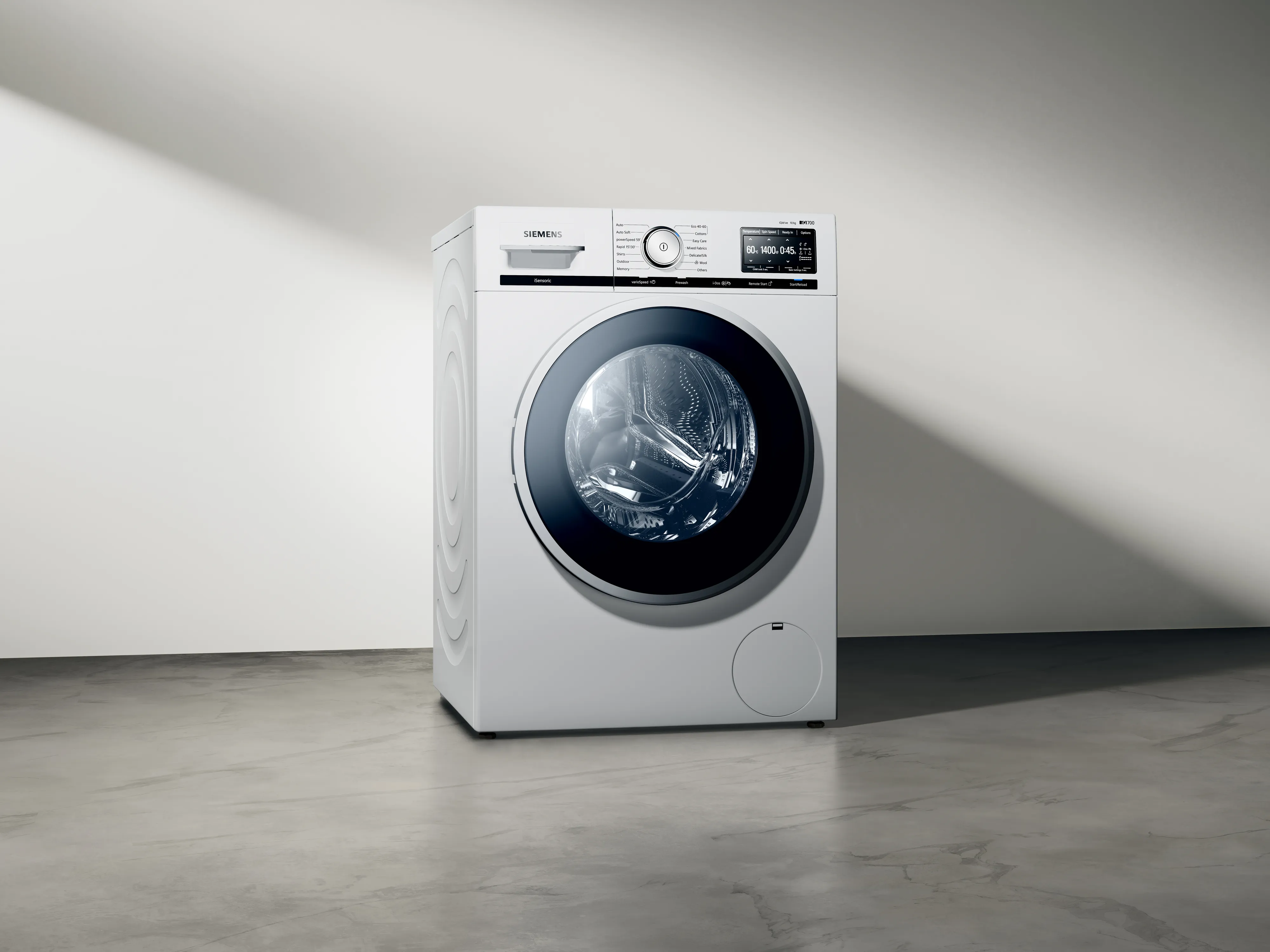 White washing machine with digital display in minimalist room.