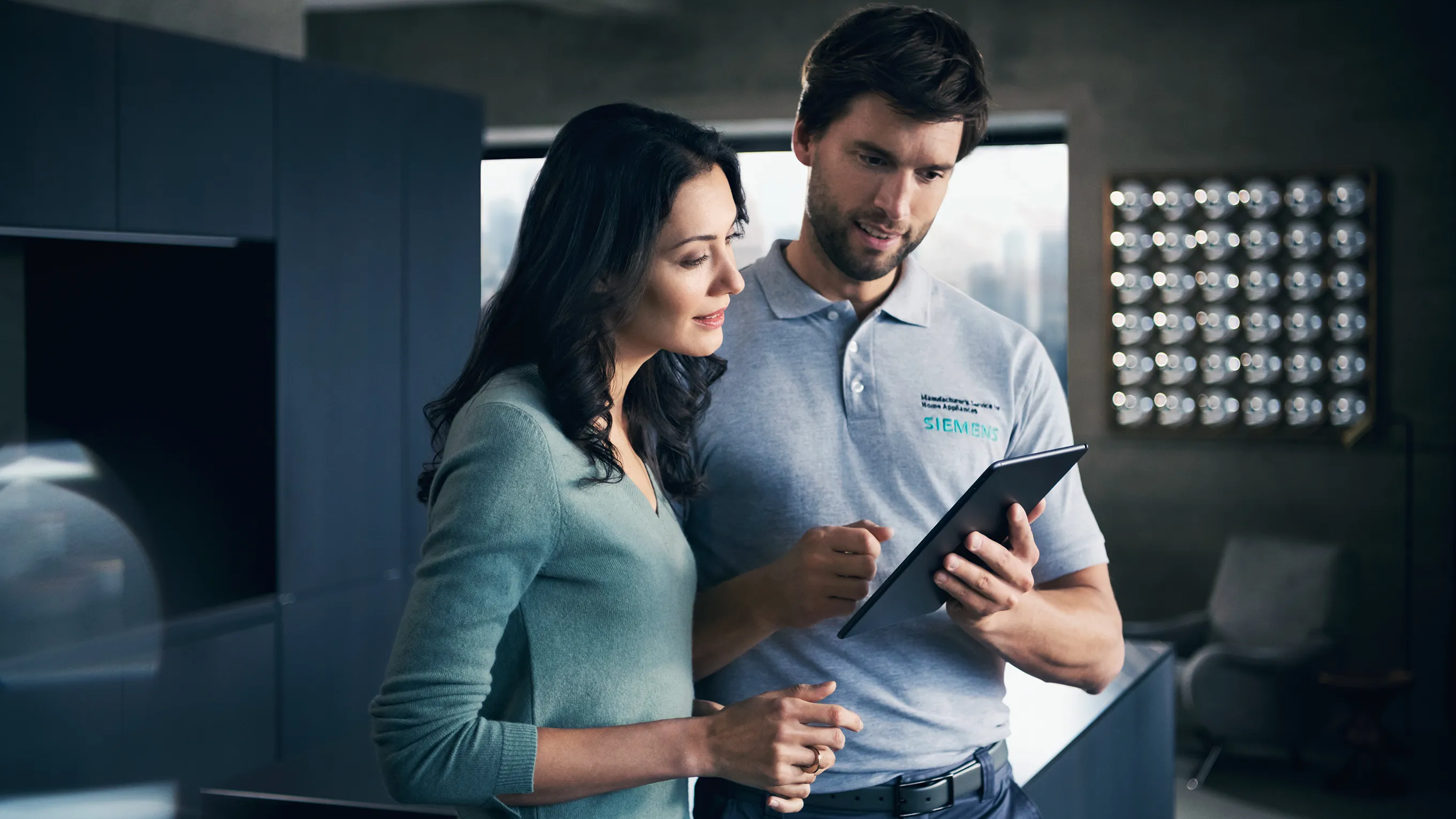 Two professionals reviewing documents in an office setting.