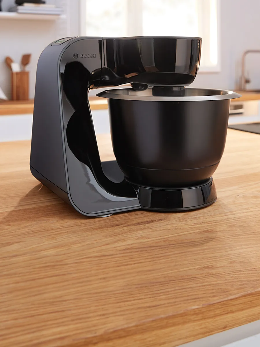 A black MUM5 stand mixer.