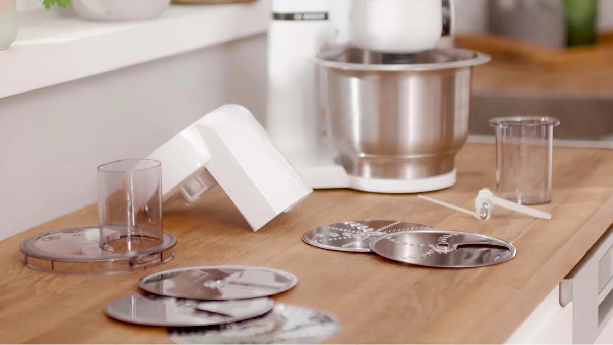 Kitchen counter with various cooking utensils, appliances, and tools.