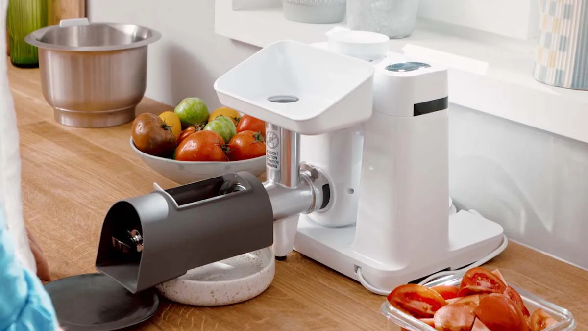 Kitchen counter with various kitchen appliances and fresh produce.