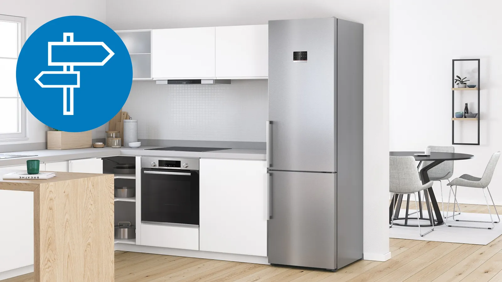Modern kitchen with white cabinets, stainless steel refrigerator, and wooden countertop.