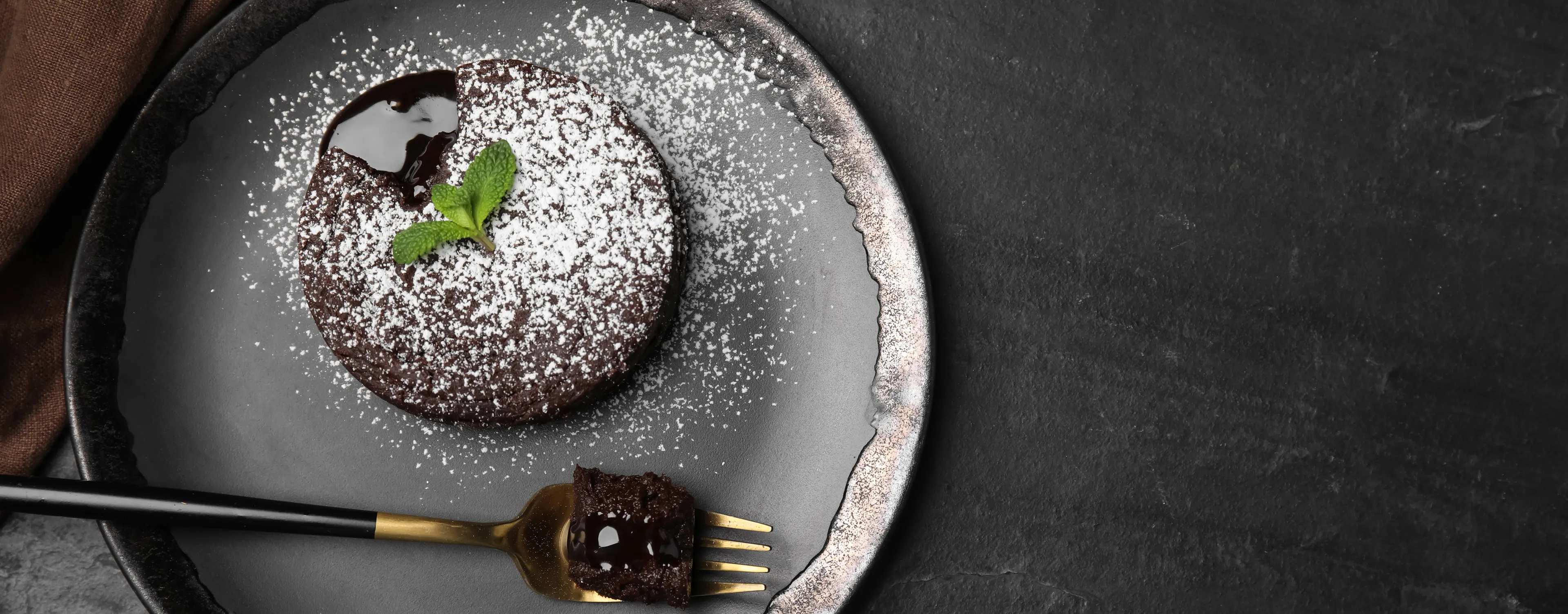 Dark chocolate and stout fondant on a plate.