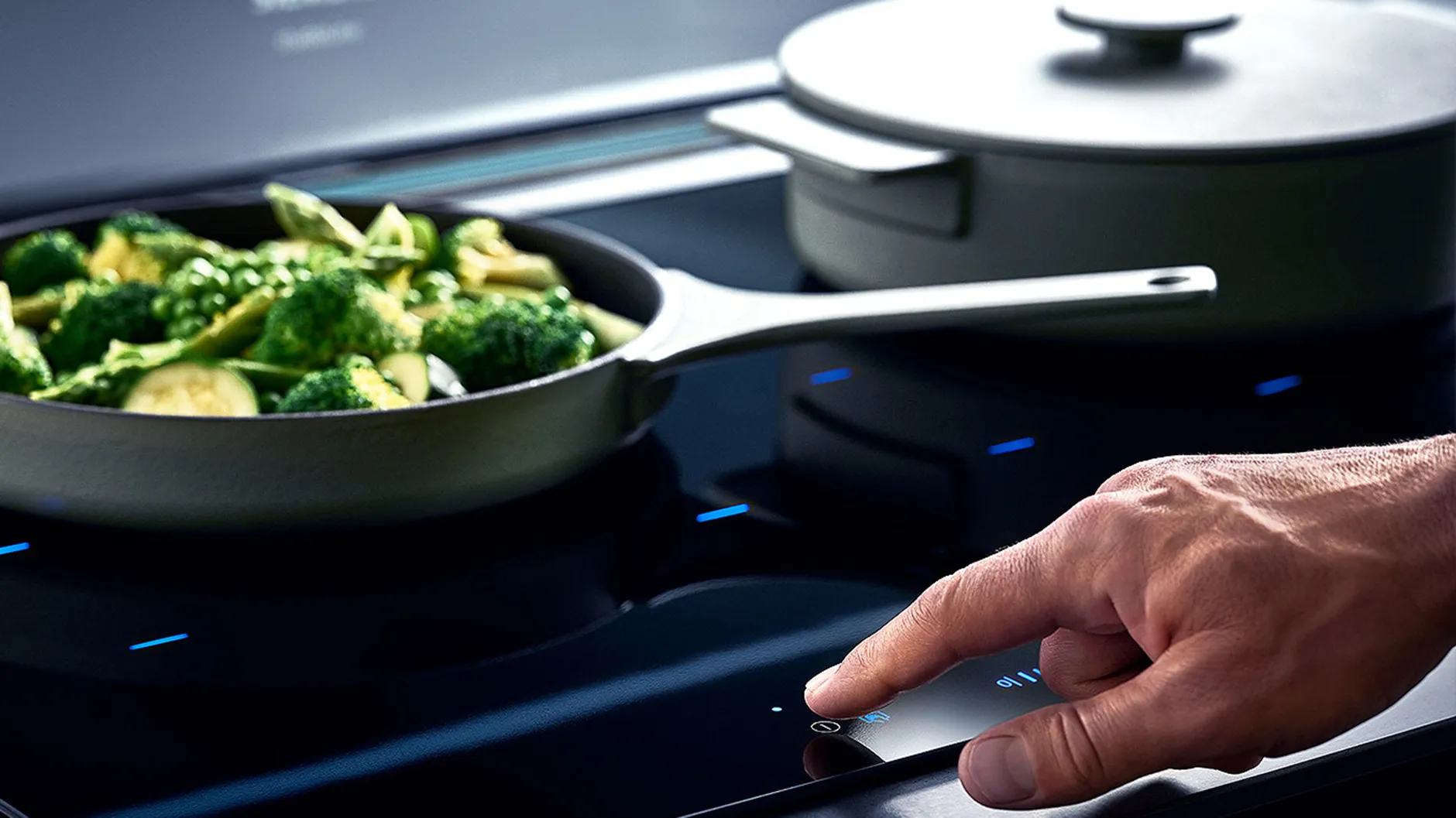 Person using control panel on induction hob