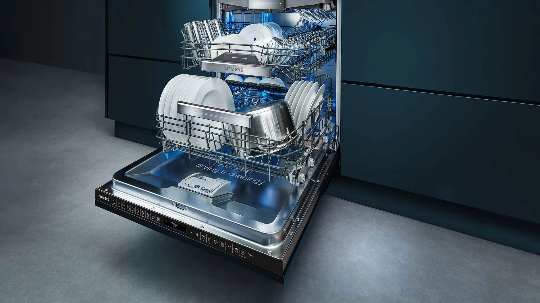 Open dishwasher with clean dishes and cutlery inside, modern kitchen appliance.