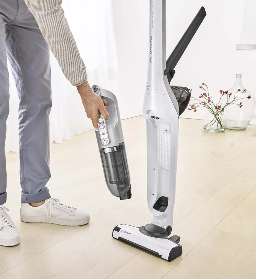 Man clicking the handheld vacuum out of the Flexxo's body.