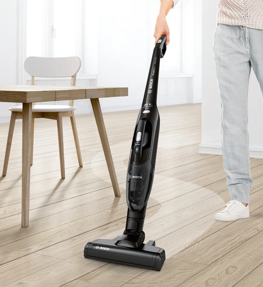 Person quickly cleaning up the hardwood floor with Readyy'y.