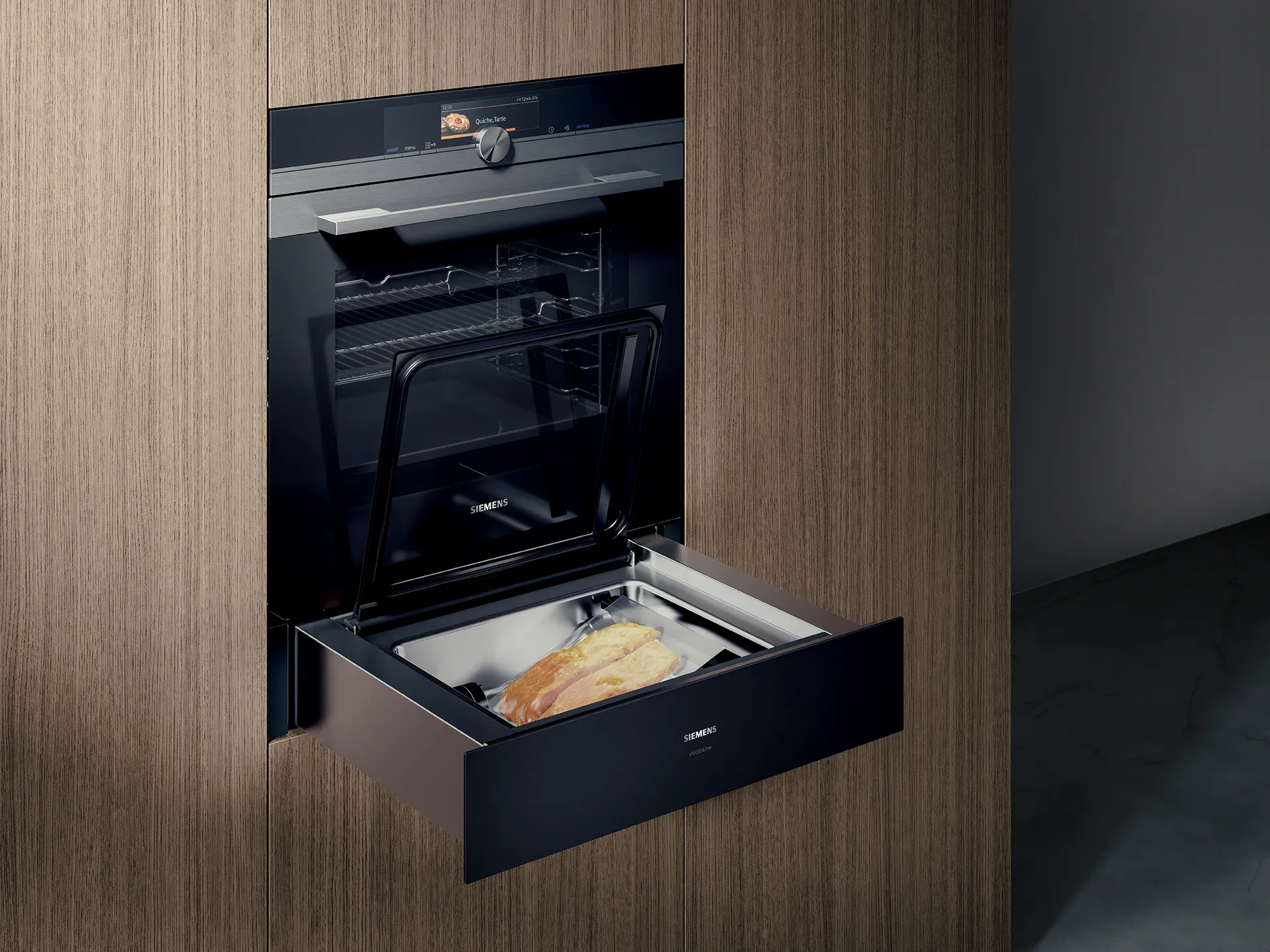 Built-in oven with open drawer, displaying a baked item inside.