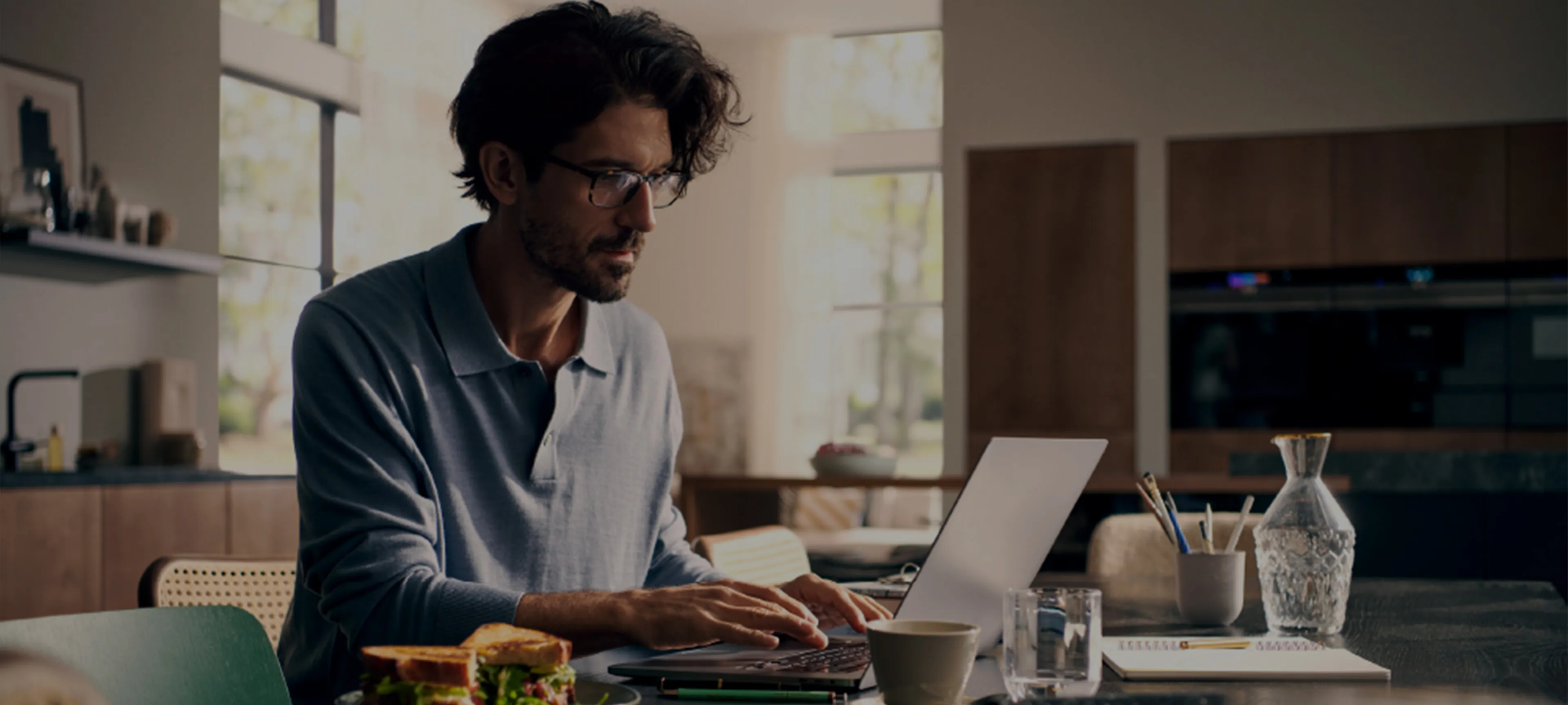 Man working at table with laptop