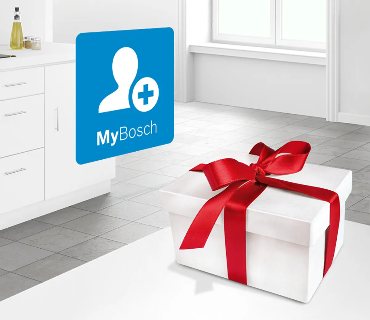 Scatola regalo bianca con nastro rosso sul pavimento, accanto al logo MyBosch in cucina moderna.