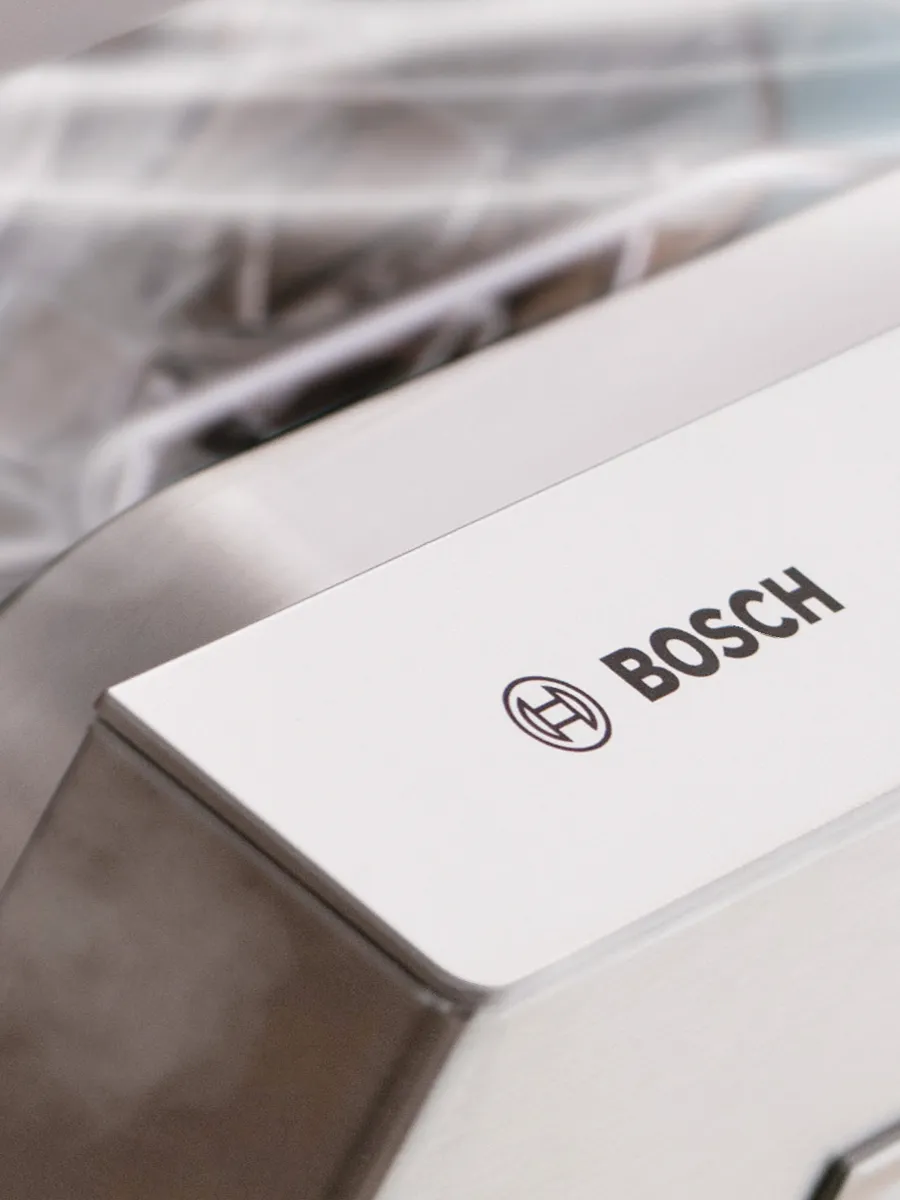 Close-up of Bosch branding on a dishwasher, reflecting the rigorous quality checks for durability and trusted performance.