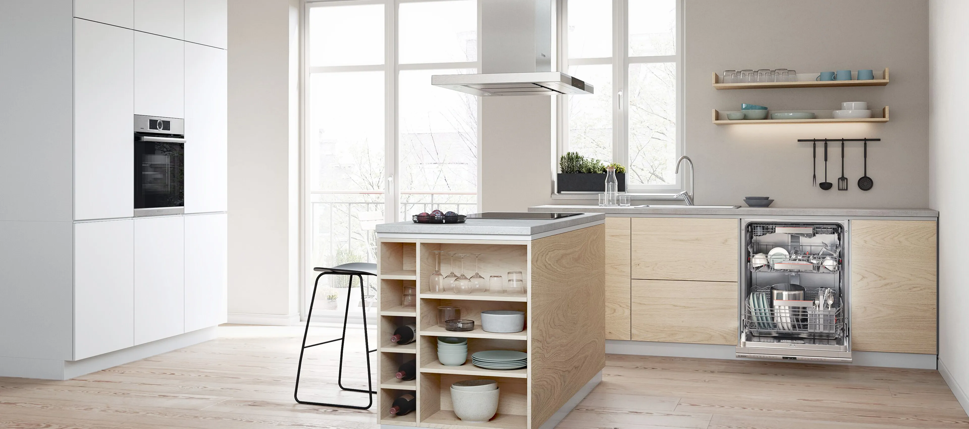A modern kitchen featuring an open dishwasher loaded with clean dishes.
