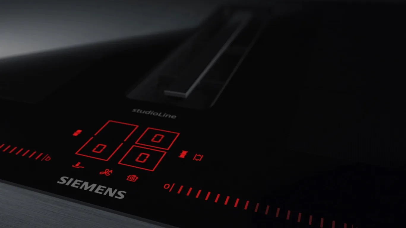 Closeup of a black Siemens appliance control panel with red digital display and buttons.