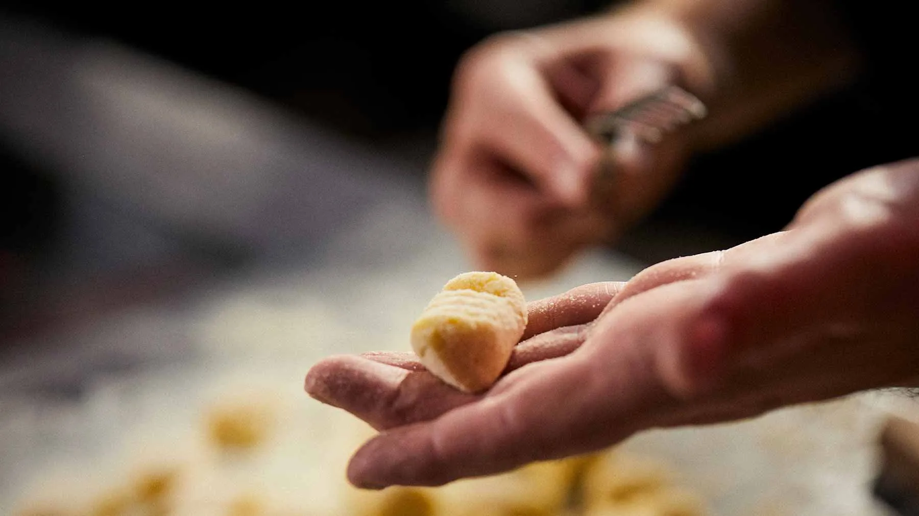 Hands kneading dough, close-up view of the process of making bread or pastry.