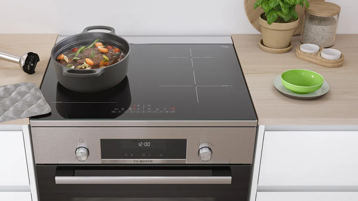 Large pot on a Bosch freestanding cooker with induction hob, designed to fit seamlessly into kitchens of all sizes.
