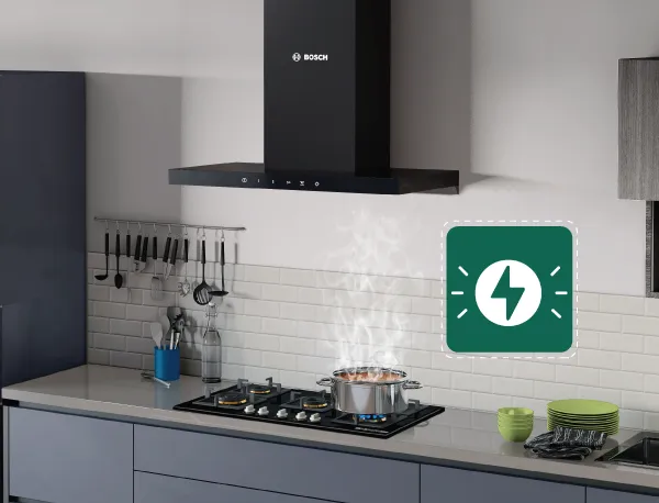 A black Bosch chimney hood over a stovetop with a steaming pot, and a green icon with a lightning bolt.