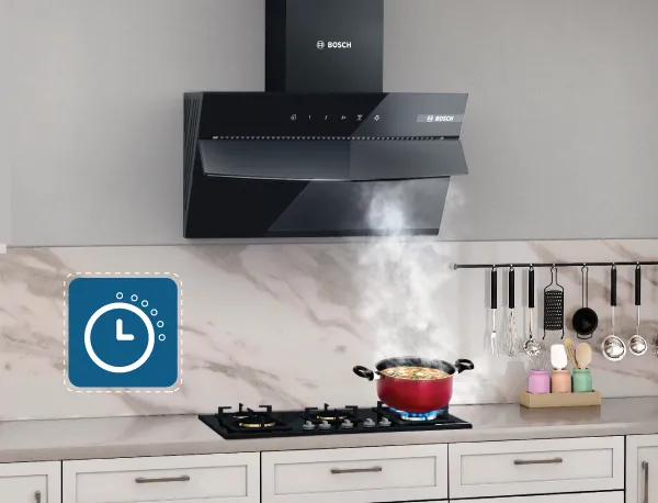 Angled Bosch kitchen chimney extracting steam from a pot, featuring a blue timer icon.