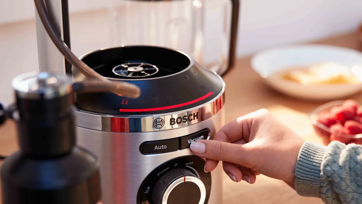A person pushing the vacuum button on the VitaPower Series 8 blender.