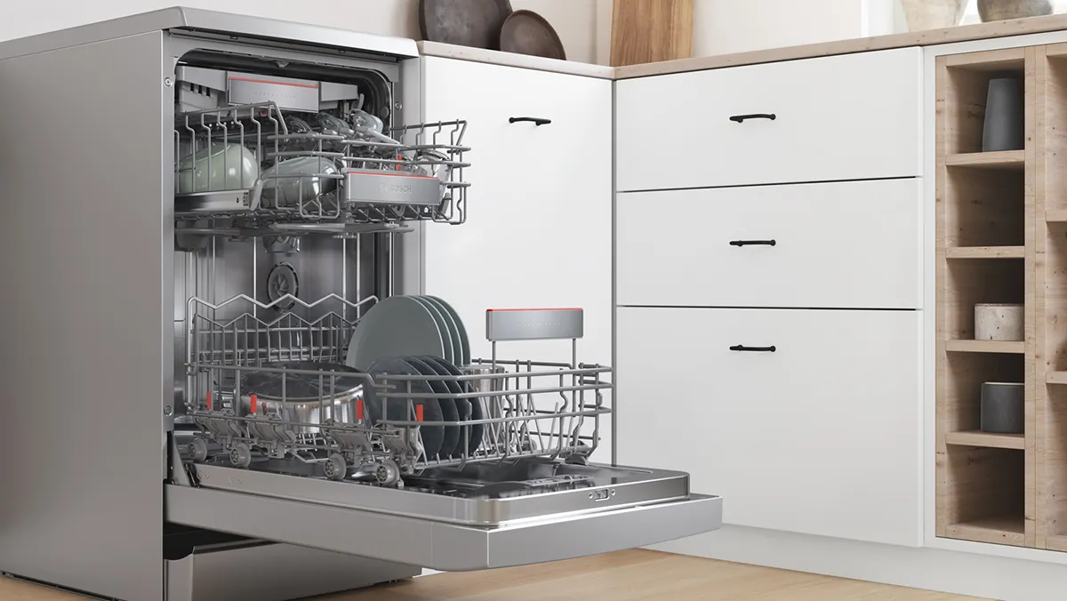 An open dishwasher filled with dishes in a modern kitchen setting.