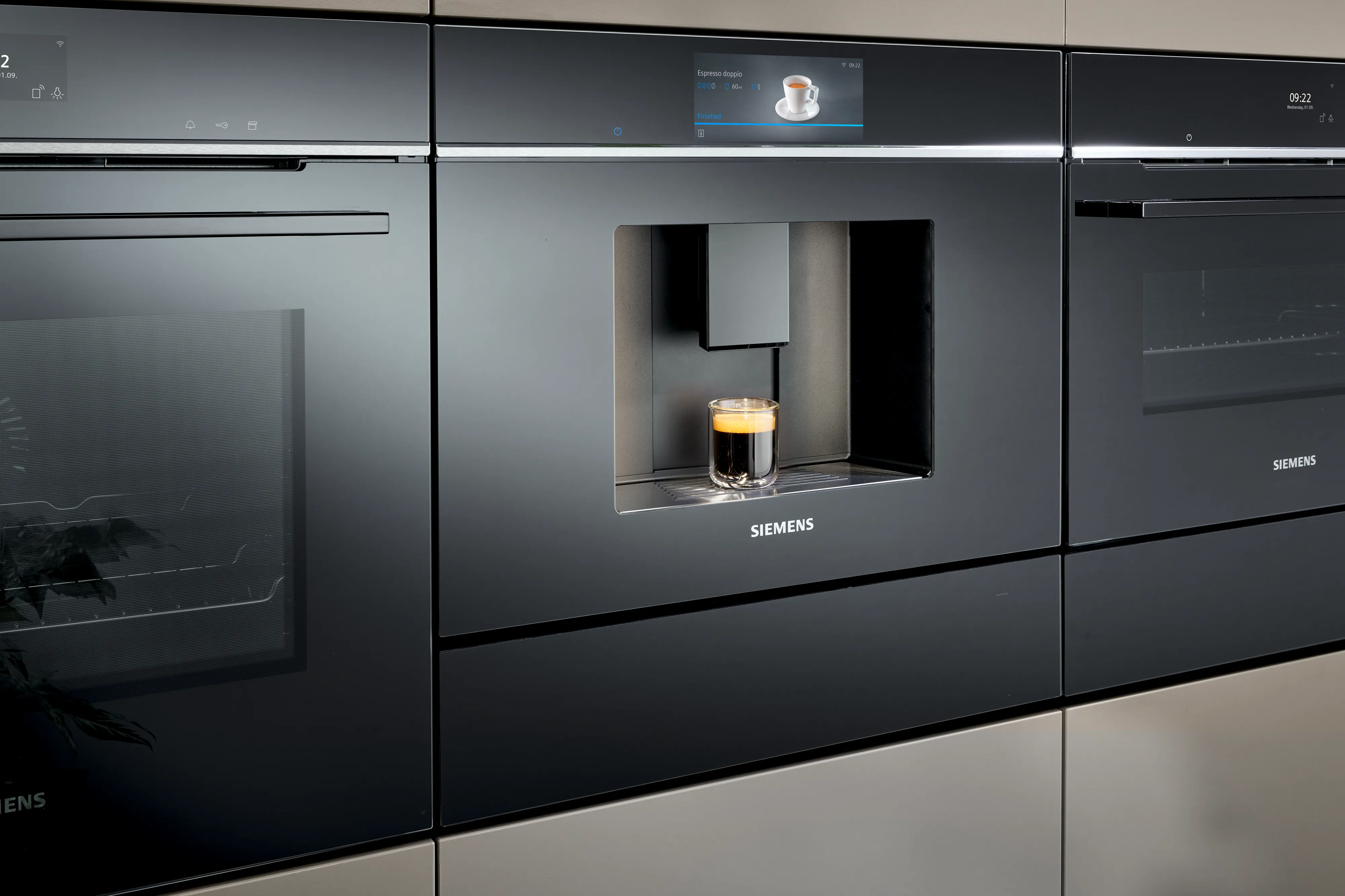 Sleek built-in coffee machine in modern kitchen cabinet.