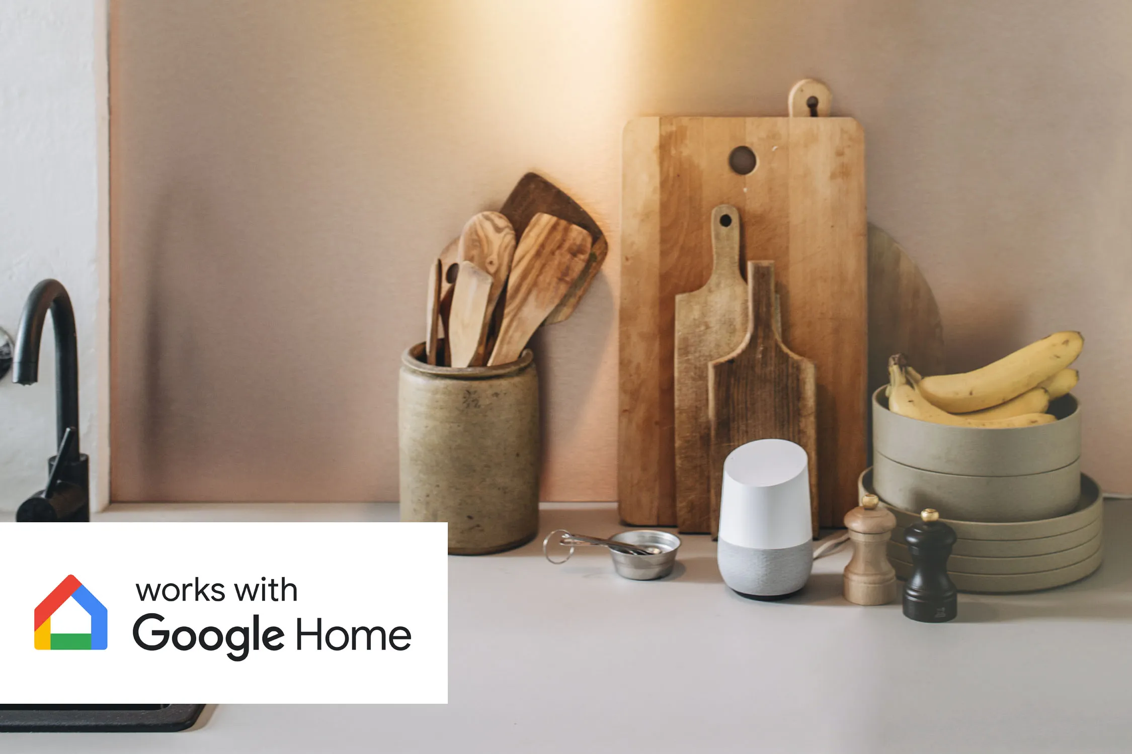 Kitchen counter with boards, bananas, spices, and a smart speaker that works with Google Home.