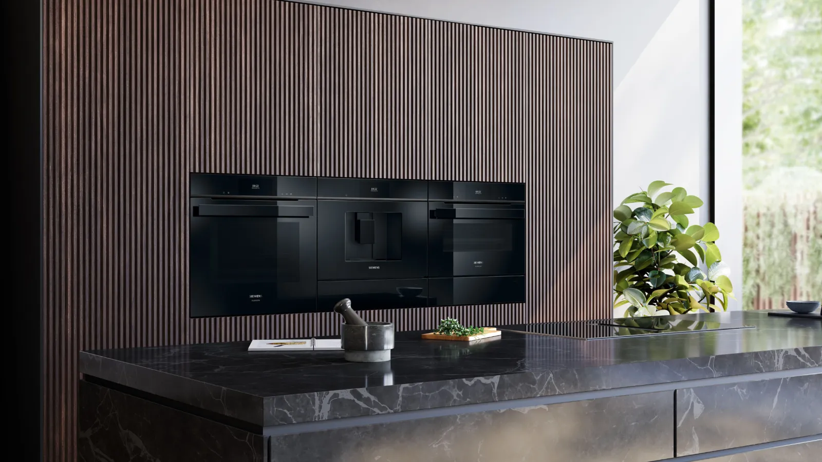 Moderne keuken met zwart inbouwapparaat, houten panelen, marmeren aanrecht en een groene plant.
