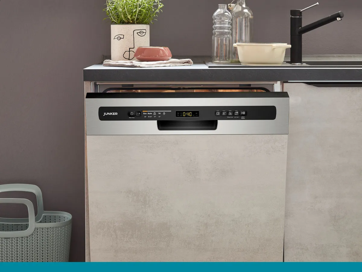 A slightly open Junker built-in dishwasher with a visible stainless steel control panel in a modern kitchen.