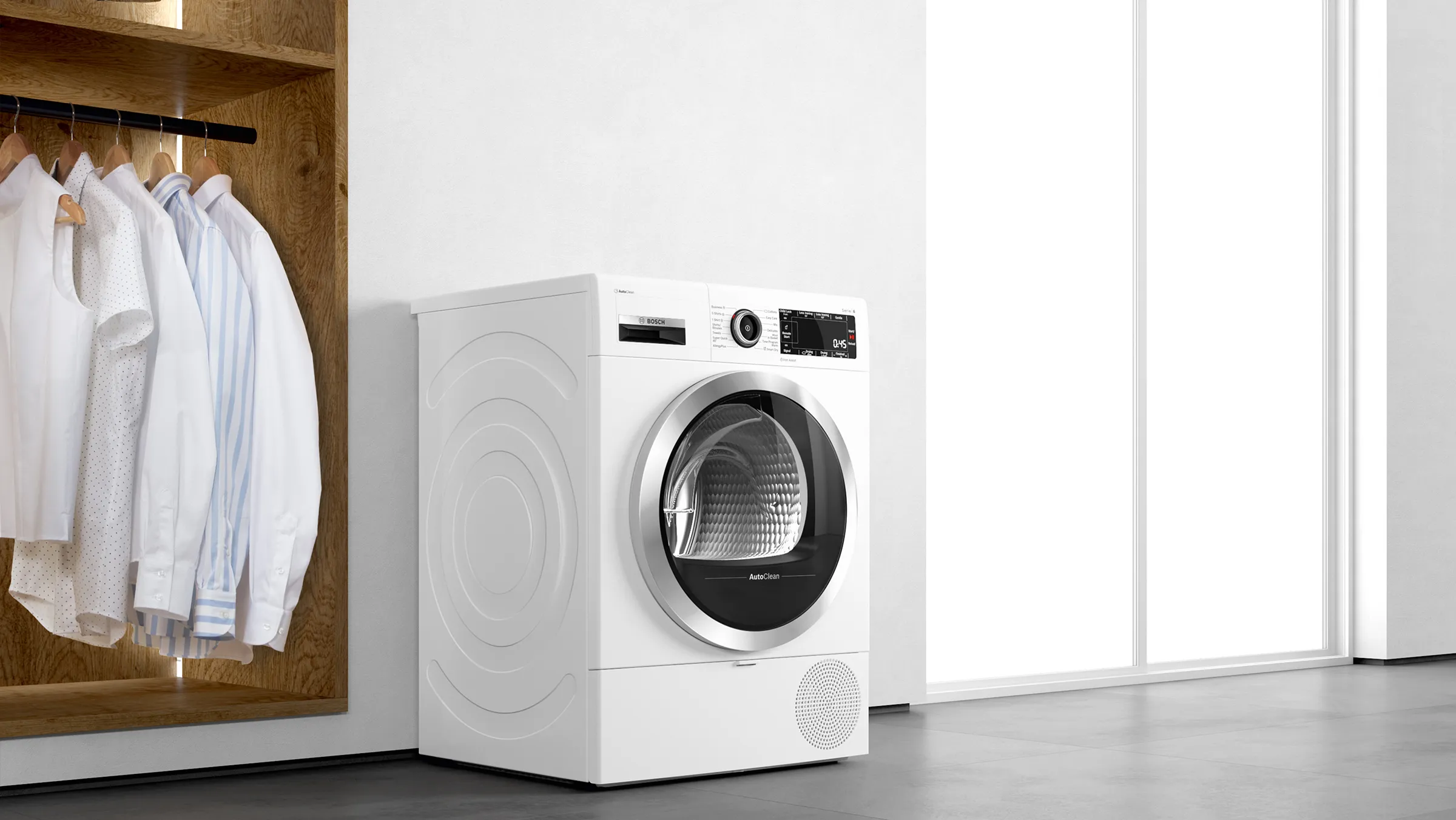 Folded coloured clothes on top of a washer