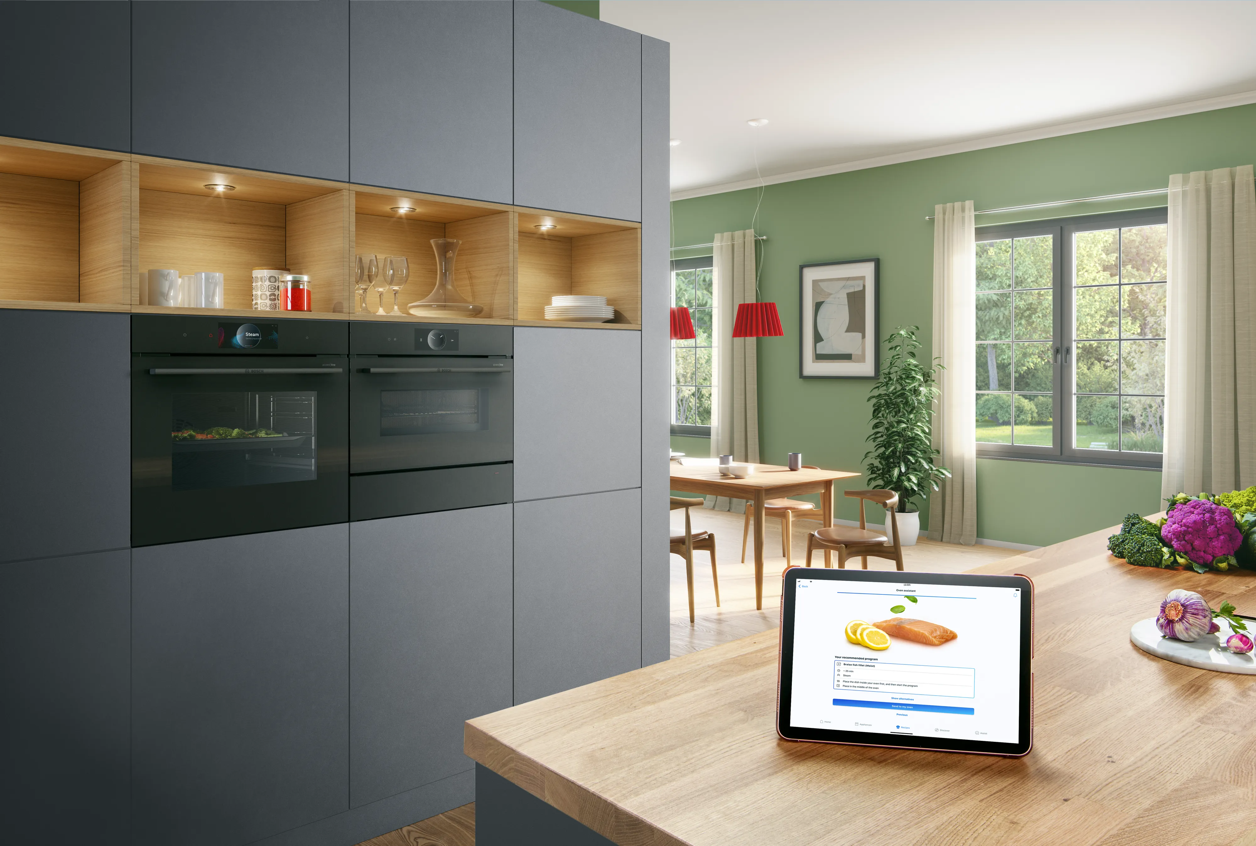 Bosch built in ovens in kitchen with tablet screen on countertop